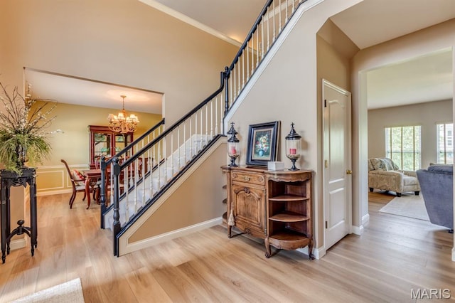 3026 Windsor Point Dr, Saint Louis, MO 63129 - stairs featuring wood finished floors and a chandelier