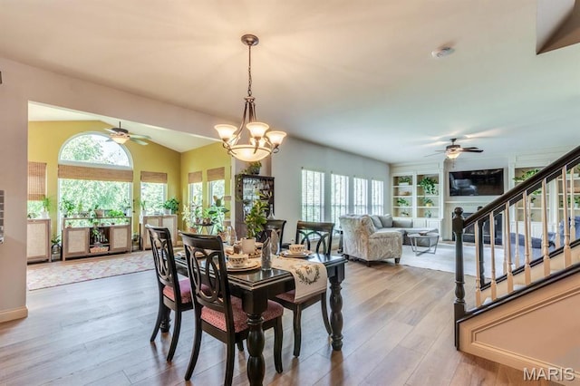 3026 Windsor Point Dr, Saint Louis, MO 63129 - dining space featuring a ceiling fan, wood finished floors, lofted ceiling, and stairway