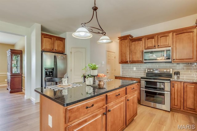 3026 Windsor Point Dr, Saint Louis, MO 63129 - kitchen with appliances with stainless steel finishes, light wood-style floors, backsplash, and dark stone countertops