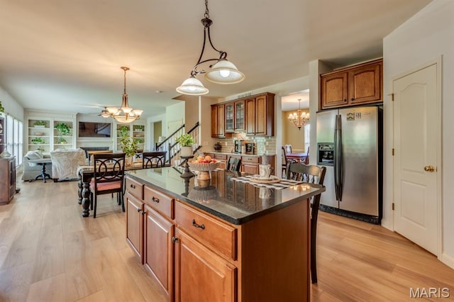 3026 Windsor Point Dr, Saint Louis, MO 63129 - kitchen featuring stainless steel fridge with ice dispenser, a chandelier, light wood-style floors, brown cabinets, and open floor plan