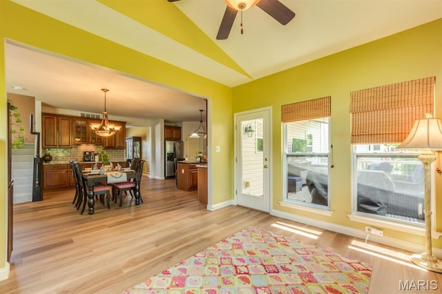 3026 Windsor Point Dr, Saint Louis, MO 63129 - dining area with vaulted ceiling, a chandelier, light wood-style flooring, and a ceiling fan