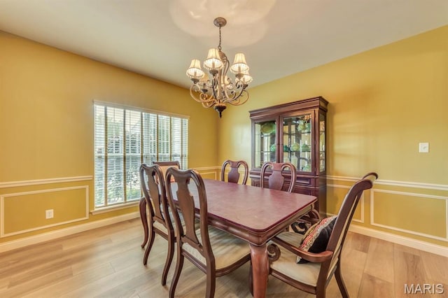 3026 Windsor Point Dr, Saint Louis, MO 63129 - dining area with a chandelier, light wood-style flooring, and wainscoting