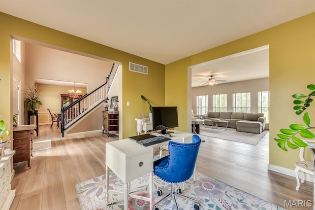 3026 Windsor Point Dr, Saint Louis, MO 63129 - living area with wood finished floors, a chandelier, stairway, an office area, and ceiling fan