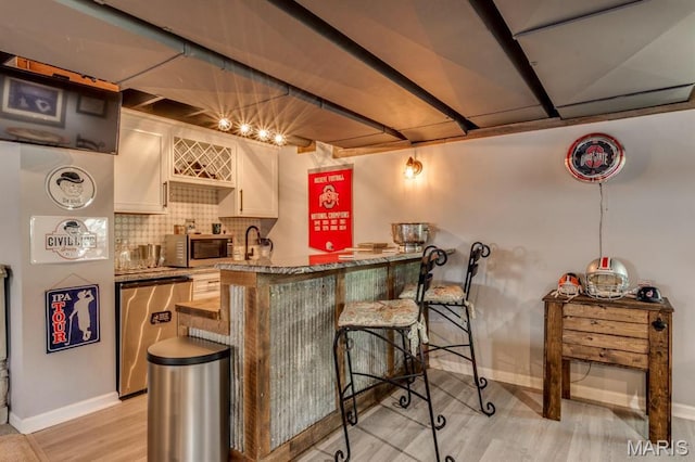 3026 Windsor Point Dr, Saint Louis, MO 63129 - indoor wet bar with refrigerator, stainless steel microwave, decorative backsplash, and light wood finished floors