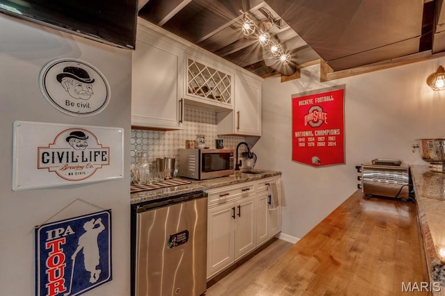 3026 Windsor Point Dr, Saint Louis, MO 63129 - kitchen with refrigerator, stainless steel microwave, backsplash, white cabinets, and light wood-style flooring