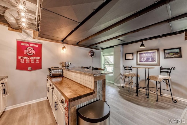 3026 Windsor Point Dr, Saint Louis, MO 63129 - kitchen featuring light wood-style floors, a peninsula, butcher block countertops, and beamed ceiling