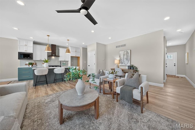 554 Wheatfield Cir, Ofallon, MO 63385 - living room with light wood finished floors, ceiling fan, and recessed lighting