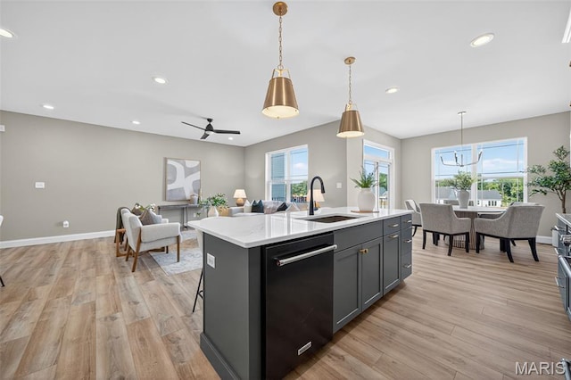 554 Wheatfield Cir, Ofallon, MO 63385 - kitchen featuring dishwasher, light wood-style flooring, light countertops, an island with sink, and recessed lighting