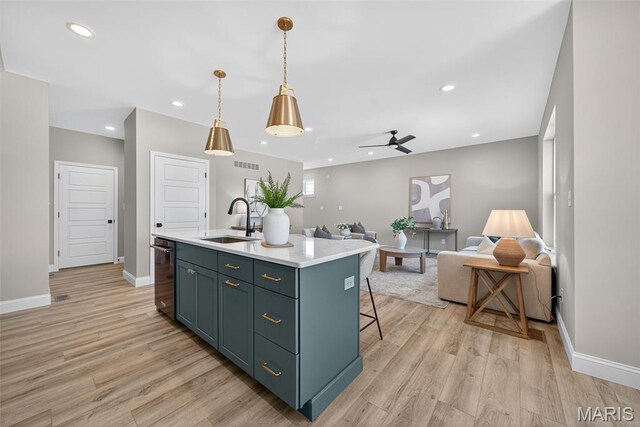 554 Wheatfield Cir, Ofallon, MO 63385 - kitchen featuring a ceiling fan, light countertops, light wood finished floors, open floor plan, and recessed lighting