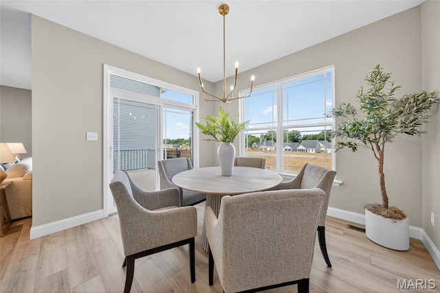 554 Wheatfield Cir, Ofallon, MO 63385 - dining space featuring a chandelier and light wood finished floors