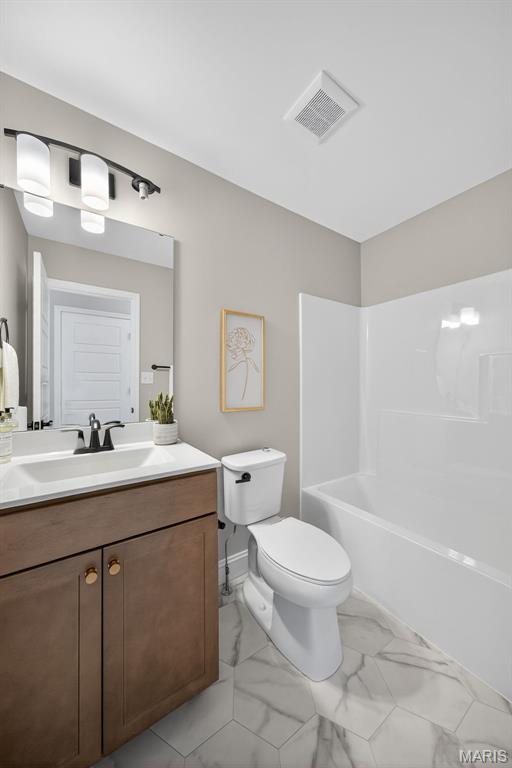 554 Wheatfield Cir, Ofallon, MO 63385 - bathroom with vanity, marble finish flooring, and shower / bath combination