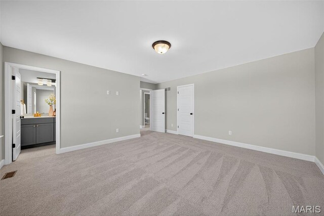 554 Wheatfield Cir, Ofallon, MO 63385 - unfurnished bedroom featuring light carpet and ensuite bathroom