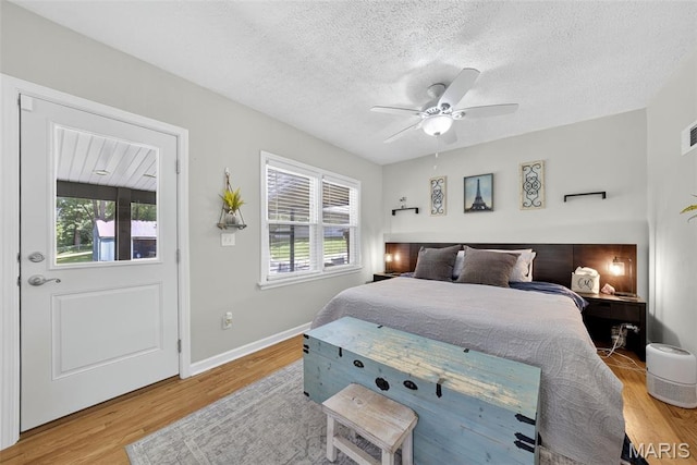 11365 Inverness Ln, Maryland Heights, MO 63043 - bedroom featuring wood finished floors, a textured ceiling, and a ceiling fan