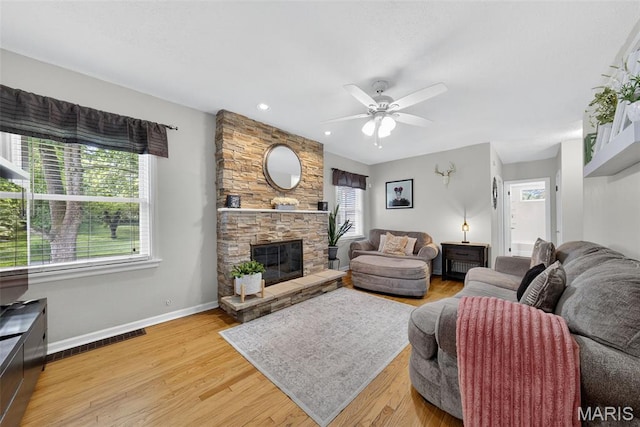 11365 Inverness Ln, Maryland Heights, MO 63043 - living area featuring ceiling fan, light wood-style floors, a stone fireplace, and recessed lighting