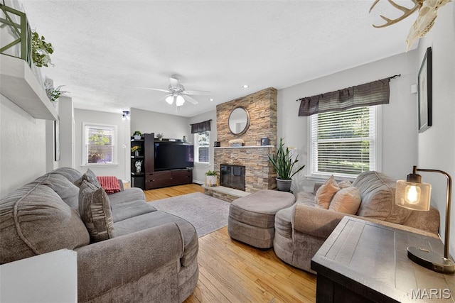 11365 Inverness Ln, Maryland Heights, MO 63043 - living area with ceiling fan, light wood-style floors, plenty of natural light, a stone fireplace, and recessed lighting