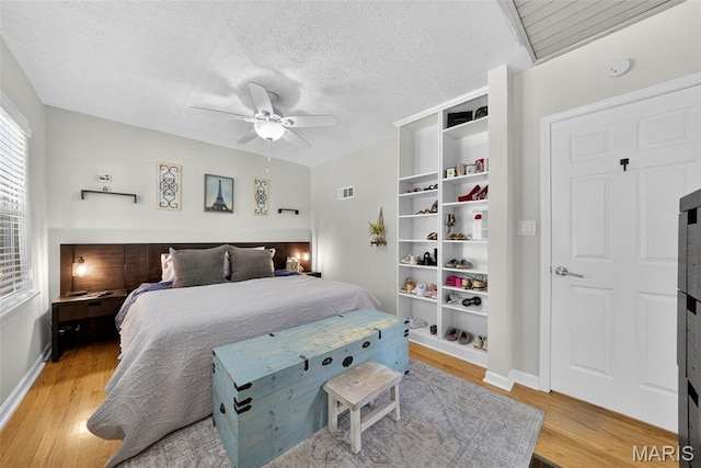 11365 Inverness Ln, Maryland Heights, MO 63043 - bedroom featuring light wood-type flooring, a textured ceiling, and a ceiling fan