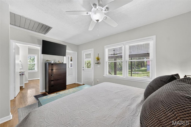 11365 Inverness Ln, Maryland Heights, MO 63043 - bedroom with a textured ceiling, wood finished floors, and a ceiling fan