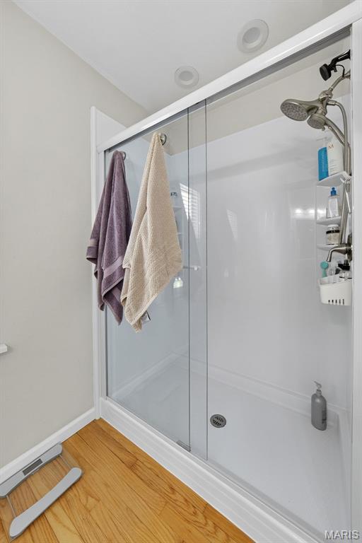 11365 Inverness Ln, Maryland Heights, MO 63043 - full bath featuring wood finished floors and a shower stall
