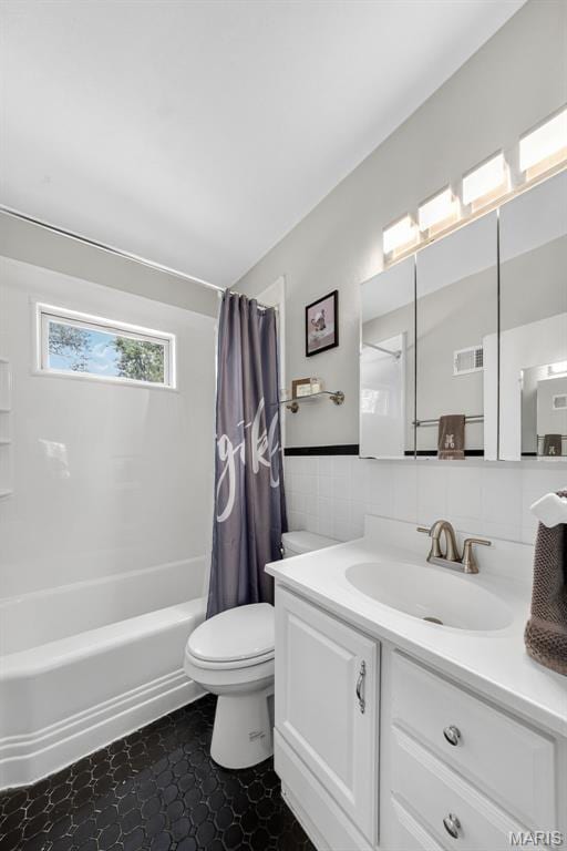 11365 Inverness Ln, Maryland Heights, MO 63043 - bathroom featuring vanity, shower / bath combination with curtain, and tile walls