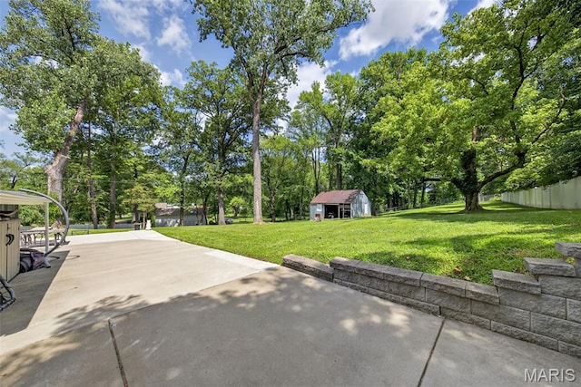 11365 Inverness Ln, Maryland Heights, MO 63043 - view of patio / terrace with an outdoor structure and view of wooded area