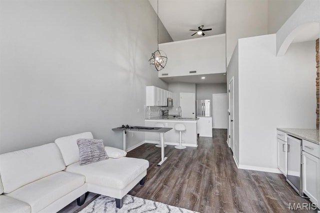 200 S Kirkwood Rd Unit 317, Kirkwood, MO 63122 - living area featuring ceiling fan, dark wood-style flooring, high vaulted ceiling, and a chandelier