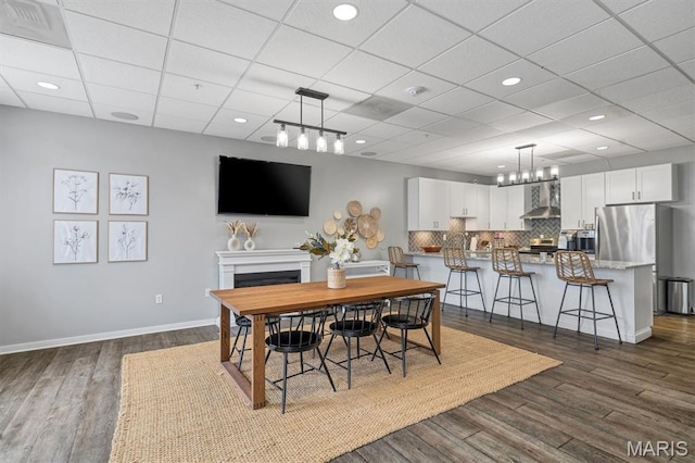 200 S Kirkwood Rd Unit 317, Kirkwood, MO 63122 - dining space featuring a fireplace, dark wood finished floors, recessed lighting, a drop ceiling, and a chandelier