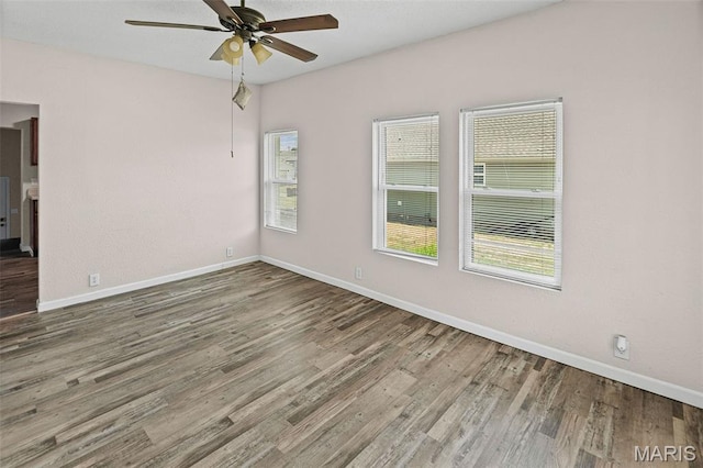 208 Washington Ave, East Alton, IL 62024 - spare room with plenty of natural light, ceiling fan, and wood finished floors