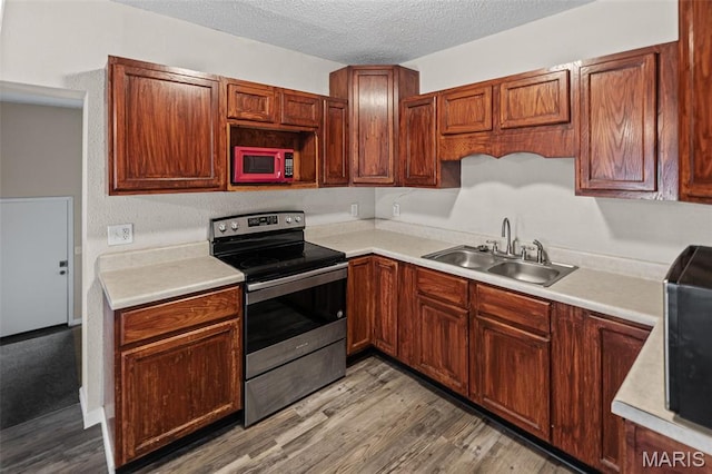 208 Washington Ave, East Alton, IL 62024 - kitchen with stainless steel electric stove, light countertops, wood finished floors, and a textured ceiling
