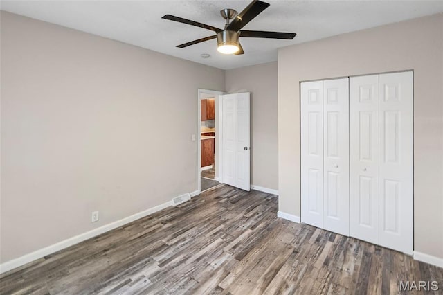208 Washington Ave, East Alton, IL 62024 - unfurnished bedroom with wood finished floors, a closet, and ceiling fan