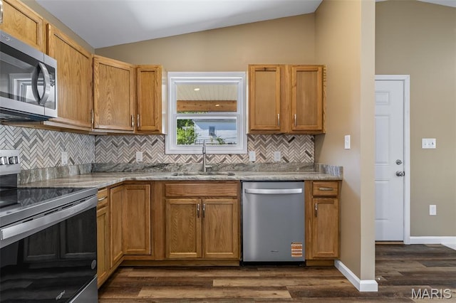 600 Allen Place, De Soto, MO 63020 - kitchen featuring stainless steel appliances, dark wood-style flooring, vaulted ceiling, tasteful backsplash, and light stone counters