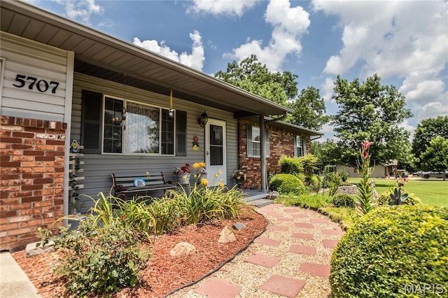 5707 Cedar Rdg, Poplar Bluff, MO 63901 - view of exterior entry with a porch and brick siding