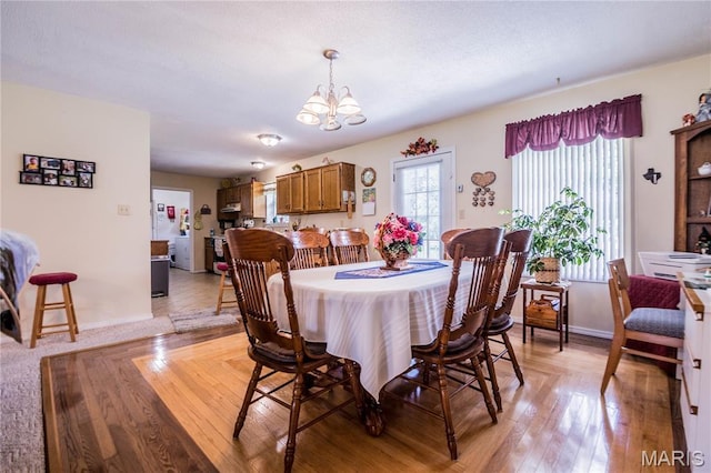 5707 Cedar Rdg, Poplar Bluff, MO 63901 - dining room featuring a chandelier and light wood-style flooring