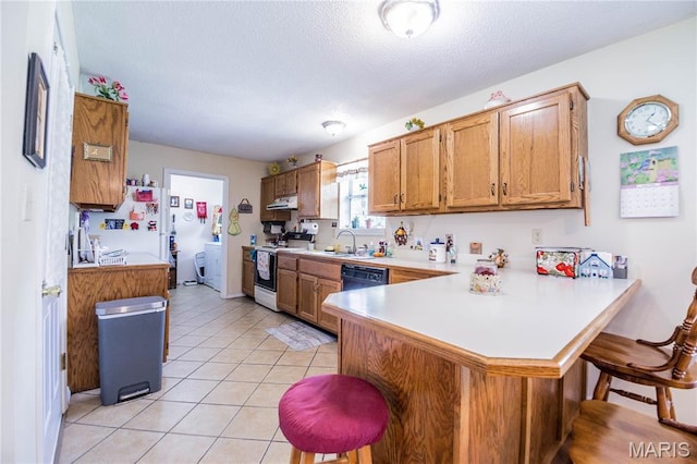 5707 Cedar Rdg, Poplar Bluff, MO 63901 - kitchen featuring white appliances, under cabinet range hood, a breakfast bar area, light countertops, and a textured ceiling