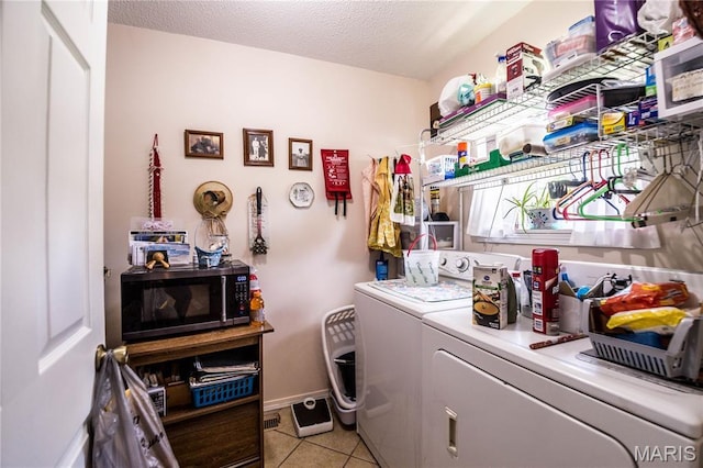 5707 Cedar Rdg, Poplar Bluff, MO 63901 - washroom featuring independent washer and dryer, light tile patterned floors, and a textured ceiling