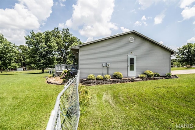 5707 Cedar Rdg, Poplar Bluff, MO 63901 - view of home's exterior featuring a wooden deck and a lawn