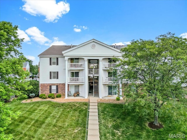 149 Jubilee Hill Dr Unit A, Wildwood, MO 63040 - view of front of home with a balcony, brick siding, a front yard, and stairway