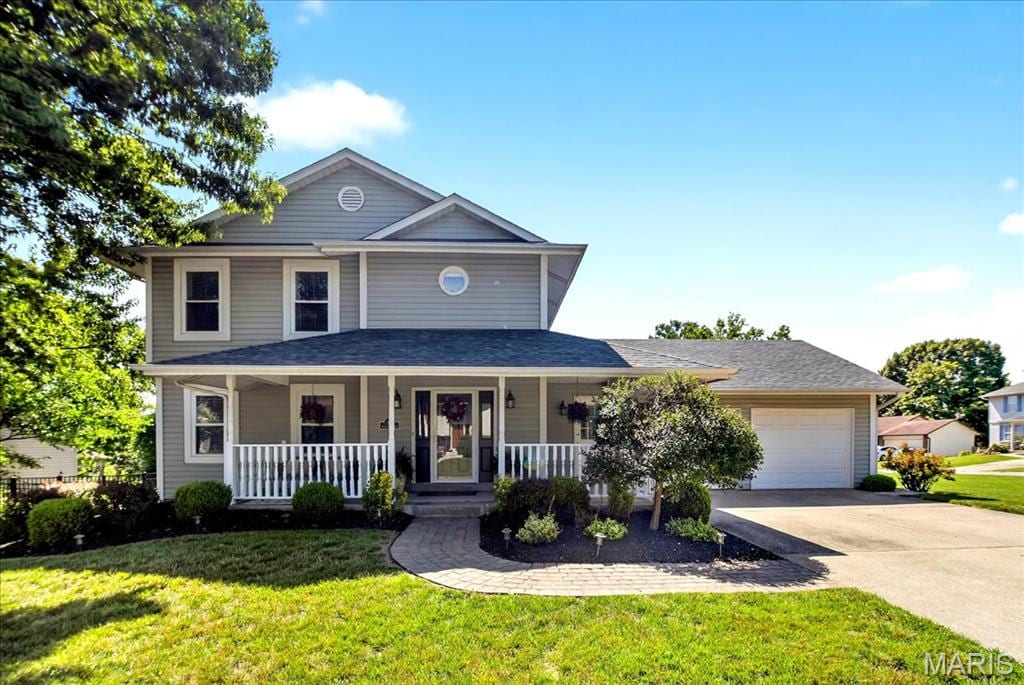 13 Spencers Xing, Saint Peters, MO 63376 - view of front of house with an attached garage, driveway, a front lawn, and covered porch