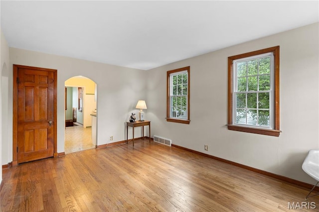 6312 Bradley Ave, Saint Louis, MO 63139 - unfurnished room featuring arched walkways and light wood-style flooring