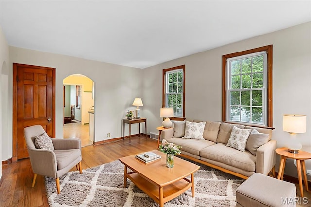 6312 Bradley Ave, Saint Louis, MO 63139 - living room with arched walkways and wood finished floors