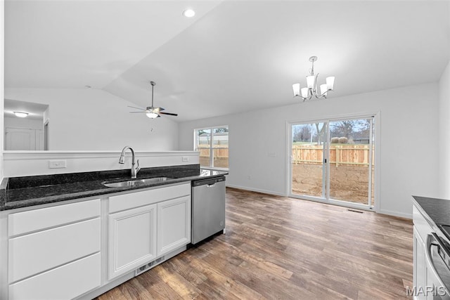 906 Gimli Ln, Wright City, MO 63390 - kitchen with stainless steel dishwasher, white cabinetry, lofted ceiling, a chandelier, and wood finished floors