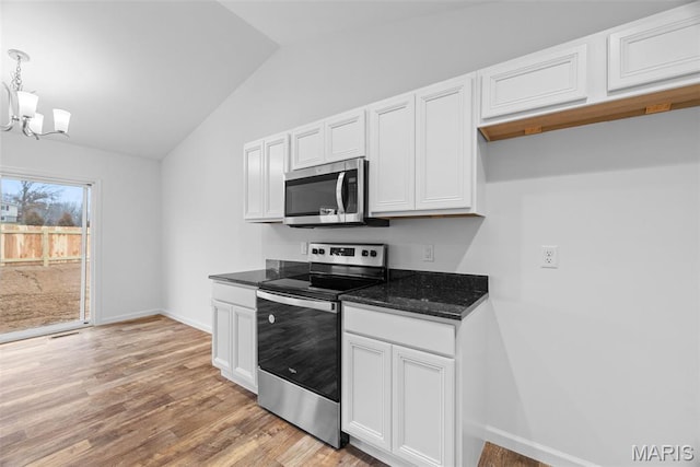 906 Gimli Ln, Wright City, MO 63390 - kitchen with appliances with stainless steel finishes, lofted ceiling, a chandelier, light wood-style floors, and white cabinetry
