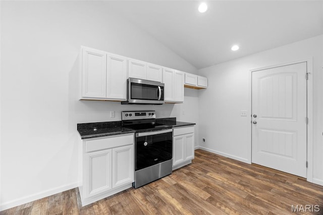 906 Gimli Ln, Wright City, MO 63390 - kitchen with appliances with stainless steel finishes, vaulted ceiling, white cabinets, dark wood finished floors, and recessed lighting