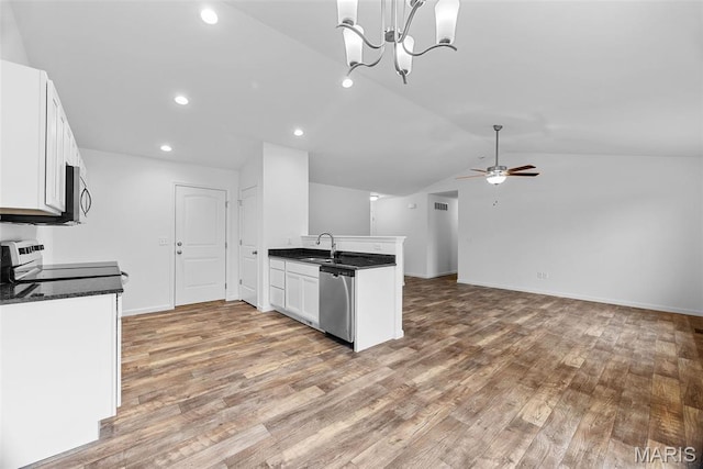 906 Gimli Ln, Wright City, MO 63390 - kitchen with appliances with stainless steel finishes, dark countertops, vaulted ceiling, white cabinetry, and wood finished floors