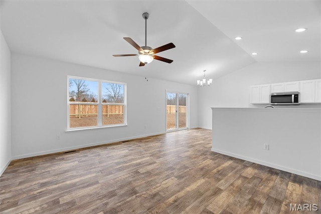 906 Gimli Ln, Wright City, MO 63390 - unfurnished living room featuring vaulted ceiling, ceiling fan, a chandelier, wood finished floors, and recessed lighting