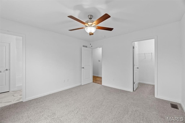 906 Gimli Ln, Wright City, MO 63390 - unfurnished bedroom featuring carpet, a spacious closet, a closet, and a ceiling fan