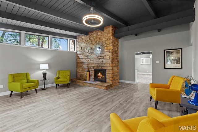 1562 Starlight Dr, Saint Louis, MO 63135 - living area featuring wood finished floors, a fireplace, and a wooden ceiling with exposed beams