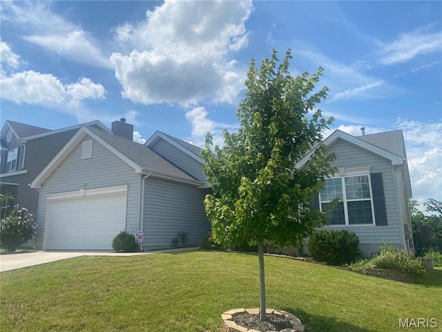145 Champions Ln, Wentzville, MO 63385 - view of side of home with a lawn, driveway, an attached garage, and a chimney