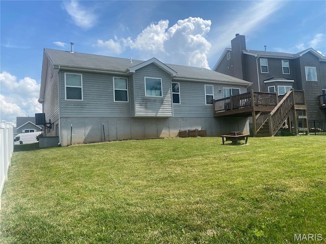 145 Champions Ln, Wentzville, MO 63385 - rear view of property with an outdoor fire pit, a lawn, and a deck