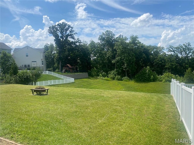 145 Champions Ln, Wentzville, MO 63385 - fenced backyard featuring an outdoor fire pit