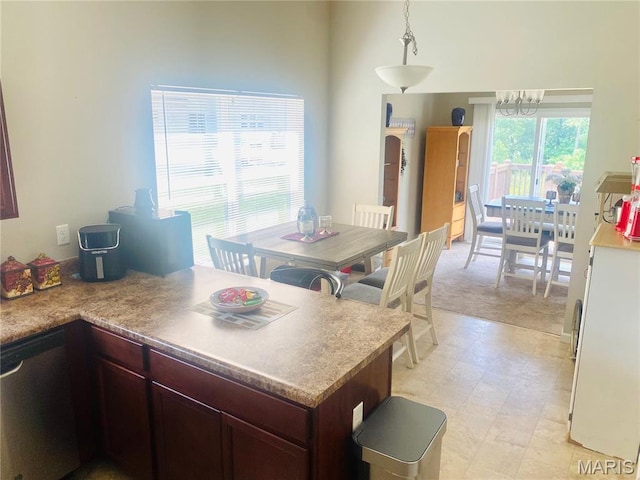 145 Champions Ln, Wentzville, MO 63385 - kitchen with a chandelier, a peninsula, hanging light fixtures, and light countertops